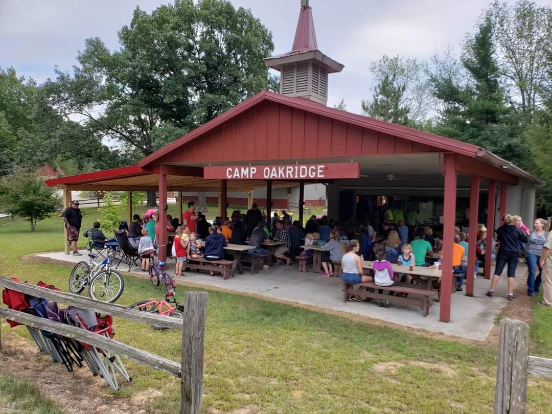 A gathering beneath the Camp Oak Ridge pavilion